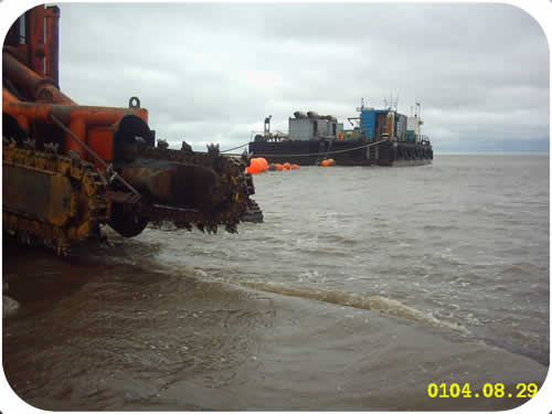 Pipeline Trenching: Subtrench One with Pontoon Barge. Click to go back.